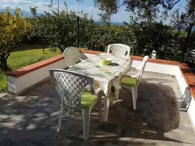 a table and chairs sitting on a patio at Casa Vacanze Daisy in Trappeto