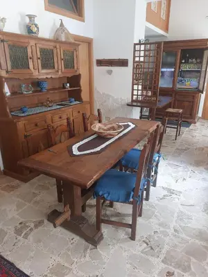a wooden table and chairs in a room at Darling in Capaci