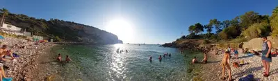 a group of people in the water at a beach at Darling in Capaci