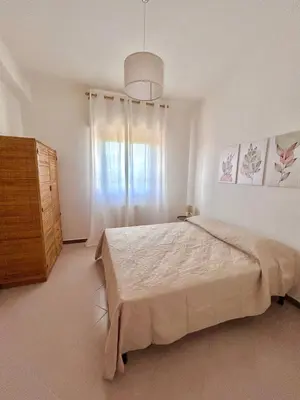 a bedroom with a large bed and a window at Villa Gargaf in Altavilla Milicia
