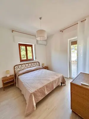 a bedroom with a large bed and a window at Villa Gargaf in Altavilla Milicia
