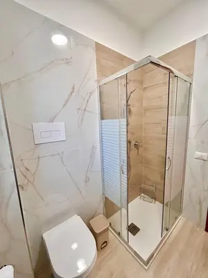 a bathroom with a shower and a toilet at Villa Gargaf in Altavilla Milicia