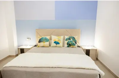 a bedroom with a large bed with two tables at B&B Terre del cretto in Nuova Gibellina