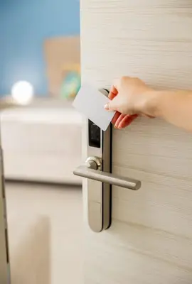 a hand unlocking a door with a piece of paper at B&B Terre del cretto in Nuova Gibellina