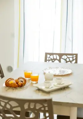 a table with a breakfast of croissants and orange juice at B&B Terre del cretto in Nuova Gibellina