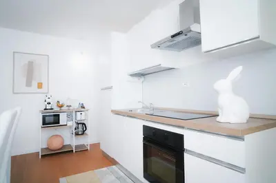 a kitchen with white walls and a black oven at Encanto Apartment in Palermo