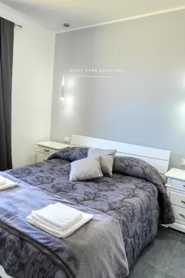 a bedroom with a bed with two towels on it at Villa Stella con piscina privata 500 mt dal mare By Sicily Home Solutions in Trappeto