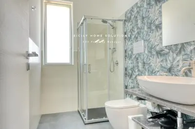 a bathroom with a shower and a sink and a toilet at Villa Stella con piscina privata 500 mt dal mare By Sicily Home Solutions in Trappeto