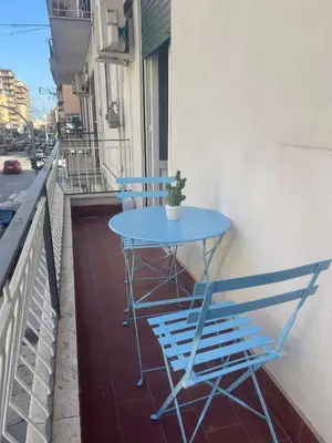 a blue table and two chairs on a balcony at Home Sampolo in Palermo