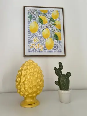 a picture of a pineapple and a cactus on a shelf at Home Sampolo in Palermo