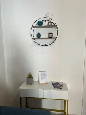 a table with a mirror on a white wall at Home Sampolo in Palermo