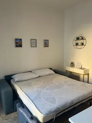 a bed in a room with a bed frame at Home Sampolo in Palermo
