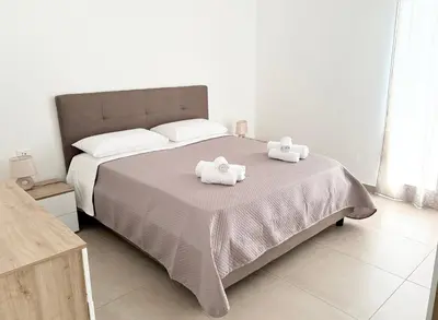 a bedroom with a bed with two towels on it at Appartamento La Duchessa in Campofelice di Roccella