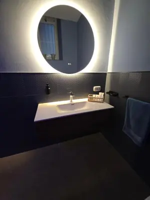 a bathroom with a sink and a mirror at Thaleia Suite & Spa in Palermo