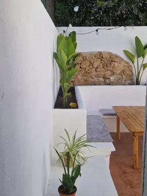 a patio with plants and a wooden table at Mammì in Balestrate