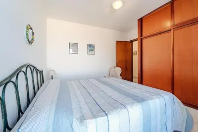 a bedroom with a bed and a wooden cabinet at Pool & Panoramic Villa - 9 mins city center in Palermo