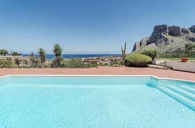 a swimming pool with a view of the ocean at Pool & Panoramic Villa - 9 mins city center in Palermo