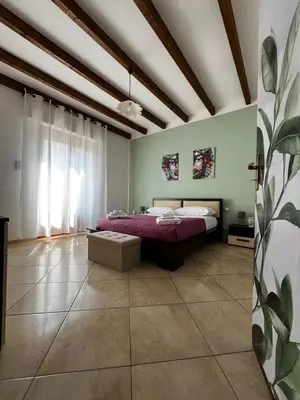 a bedroom with a purple bed in a room at Dimora del Moro in Castellammare del Golfo