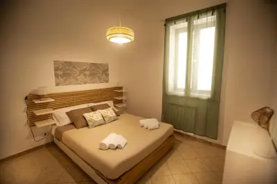 a bedroom with a bed with towels on it at Casa Alagna - La Casetta al Mare con Idromassaggio in Palermo