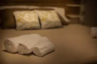 two towels sitting on top of a bed at Casa Alagna - La Casetta al Mare con Idromassaggio in Palermo