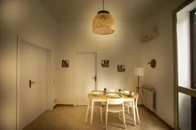 a dining room with a table and two chairs at Casa Alagna - La Casetta al Mare con Idromassaggio in Palermo