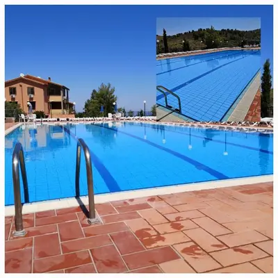 a large swimming pool with blue water at Casa Vacanze Soleado house Trabia PA, Sicily in Mandra Capreria