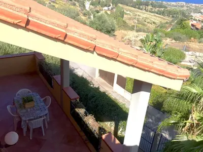 a balcony of a house with a table and chairs at Casa Vacanze Soleado house Trabia PA, Sicily in Mandra Capreria