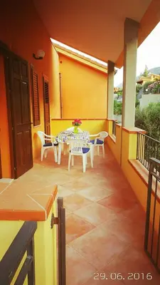 a patio with a table and chairs on a balcony at Casa Vacanze Soleado house Trabia PA, Sicily in Mandra Capreria
