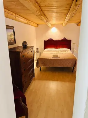 a bedroom with a bed and a dresser in a room at Mia Domus in Palermo