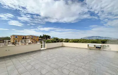 a large patio with a view of the mountains at Nice Home In Balestrate in Balestrate