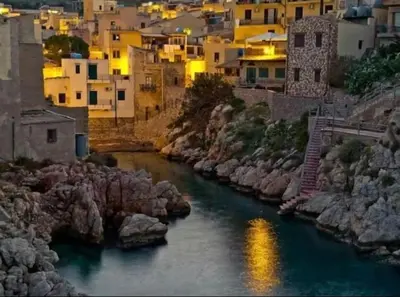 a river in a city with houses and buildings at La casa dei Nonni in Santa Flavia