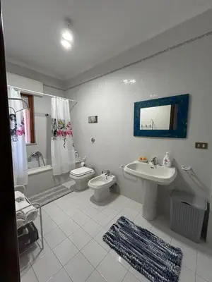 a bathroom with a sink and a toilet and a bath tub at La casa dei Nonni in Santa Flavia