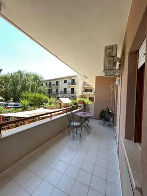 a balcony with chairs and a table on a building at La casa dei Nonni in Santa Flavia