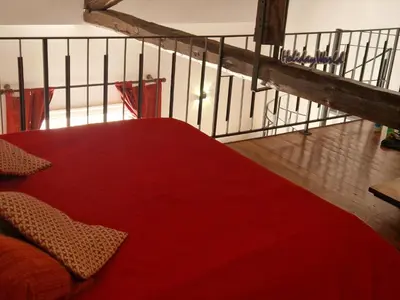 a red bed in a room with a staircase at House Vintage Charme by Holiday World in Palermo