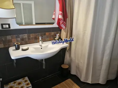 a bathroom with a sink and a shower curtain at House Vintage Charme by Holiday World in Palermo