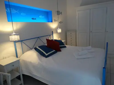 a bedroom with a white bed with two pillows at La Maschera di Giano, case vacanza vista mare in Palermo