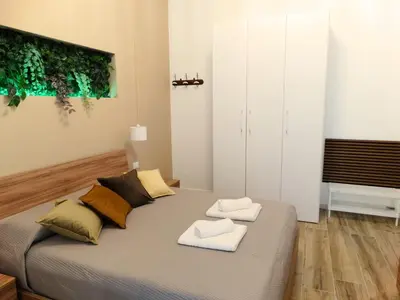 a bedroom with a bed with two towels on it at La Maschera di Giano, case vacanza vista mare in Palermo