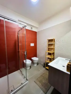a bathroom with a shower and a toilet and a sink at Villa Finch Mondello in Palermo
