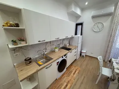 a kitchen with a sink and a washing machine at Casa Donna Ina in Palermo