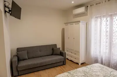 a living room with a couch and a bedroom at Casa Donna Ina in Palermo