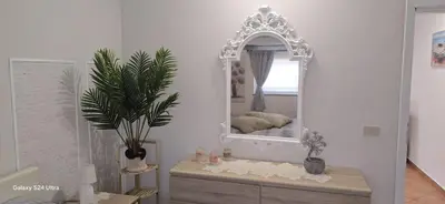 a mirror sitting on top of a dresser in a room at la casetta di nin e gian mondello in Palermo