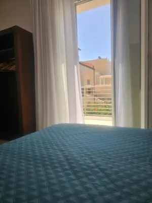 a bedroom with a bed and a large window at Alle Porte di San Vito 2 in San Vito lo Capo