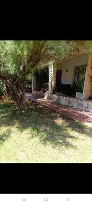 a kitchen with a table and chairs in a room at House in Garden in Palermo