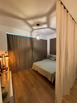 a bedroom with a bed and a wooden floor at La Casetta Panoramica in Palermo