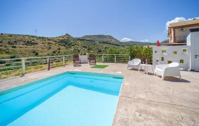 a pool on a patio with chairs and a table at Gorgeous Home In Trabia in Trabia
