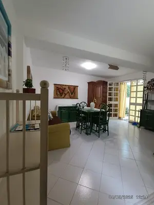 a living room and dining room with a table and chairs at Villino Sirene Mondello in Palermo