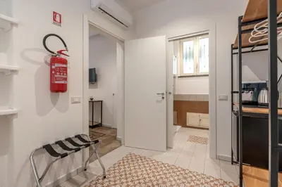 a living room with a fire extinguisher on the wall at Ai Vicoli Ciambra's Alley by Wonderful Italy in Monreale