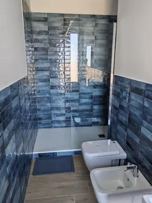 a bathroom with a toilet and a sink at MARE Suite in Palermo