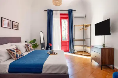 a bedroom with a bed and a television in a room at Elegant Two-Room Apartment with Balcony & Suite in Palermo