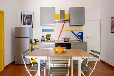 a kitchen with a table with a bowl of fruit on it at Elegant Two-Room Apartment with Balcony & Suite in Palermo